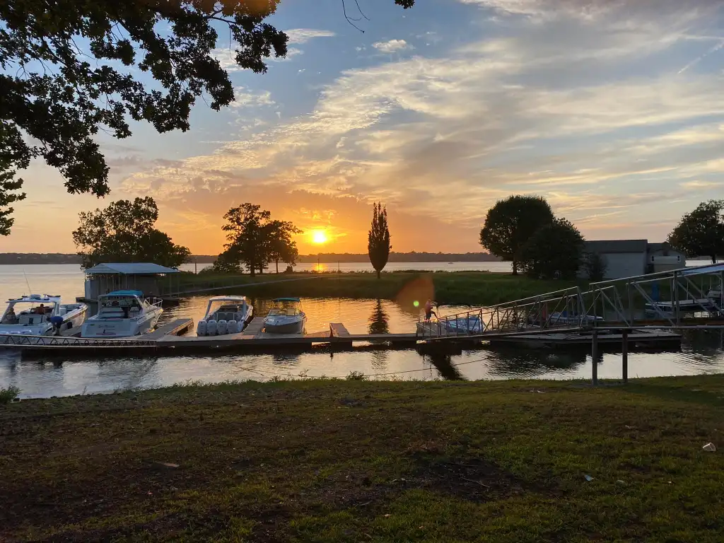 A sunset over Grand Lake and a marina